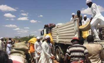 Sewadaars unloading sacks of food from a lorry in Kenya